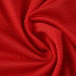 Close-up of the red textured fabric used for the SL Benfica 2025/26 Home Fan Version jersey.