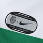 Close-up of Sporting CP 2025/26 home jersey badge with SCP crest and Nike logo, labeled as official licensed product.