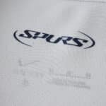 Close-up of the "SPURS" logo on the 2025/26 Tottenham Hotspur Home Fan Version jersey fabric.