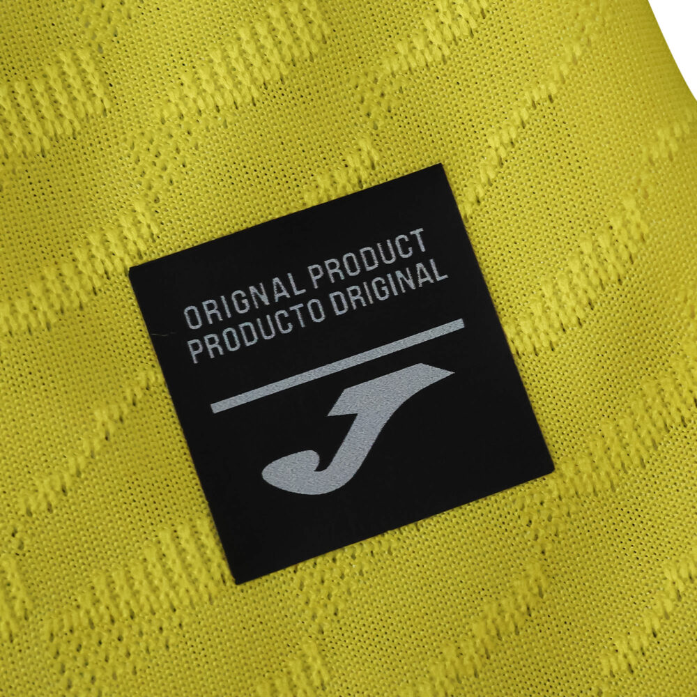 Close-up of the Villarreal 2025/26 home jersey fabric with an "Original Product" Joma label.