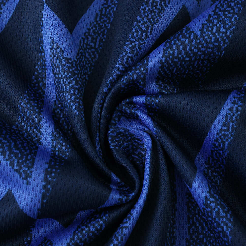 Close-up of Arsenal Away 2025/26 Player Version jersey fabric with blue zigzag pattern.