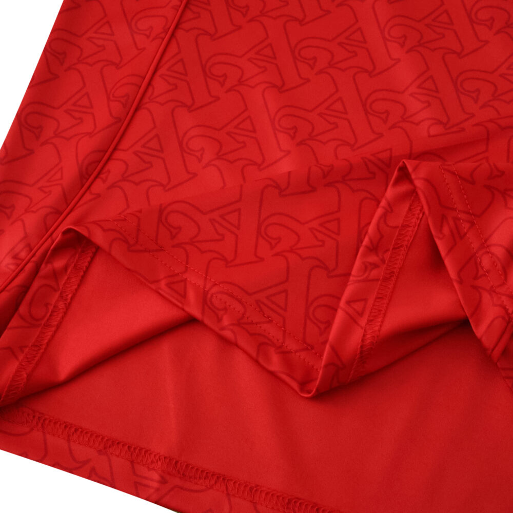 Close-up of the red Arsenal Home 2025/26 Fan Version jersey featuring an embossed graphic pattern.