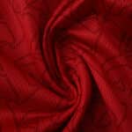 Close-up of Arsenal Home 2025/26 Player Version jersey fabric with textured red pattern.