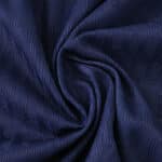 Close-up of Atlético Madrid Away 2025/26 Player Version jersey fabric in deep navy blue with textured pattern.