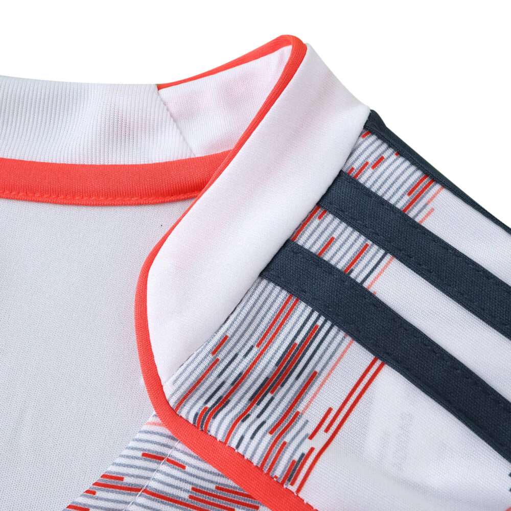 Close-up of Bayern Munich Away 2025/26 Fan Version collar and shoulder with red trim and dark stripes.