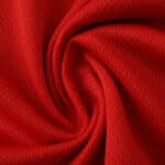 Close-up of Bayern Munich 2025/26 Home Player Version jersey fabric showing red texture and detail.