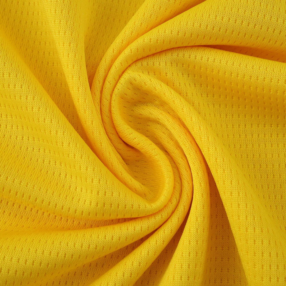 Close-up of yellow Borussia Dortmund 2025/26 home jersey fan version fabric with visible texture.
