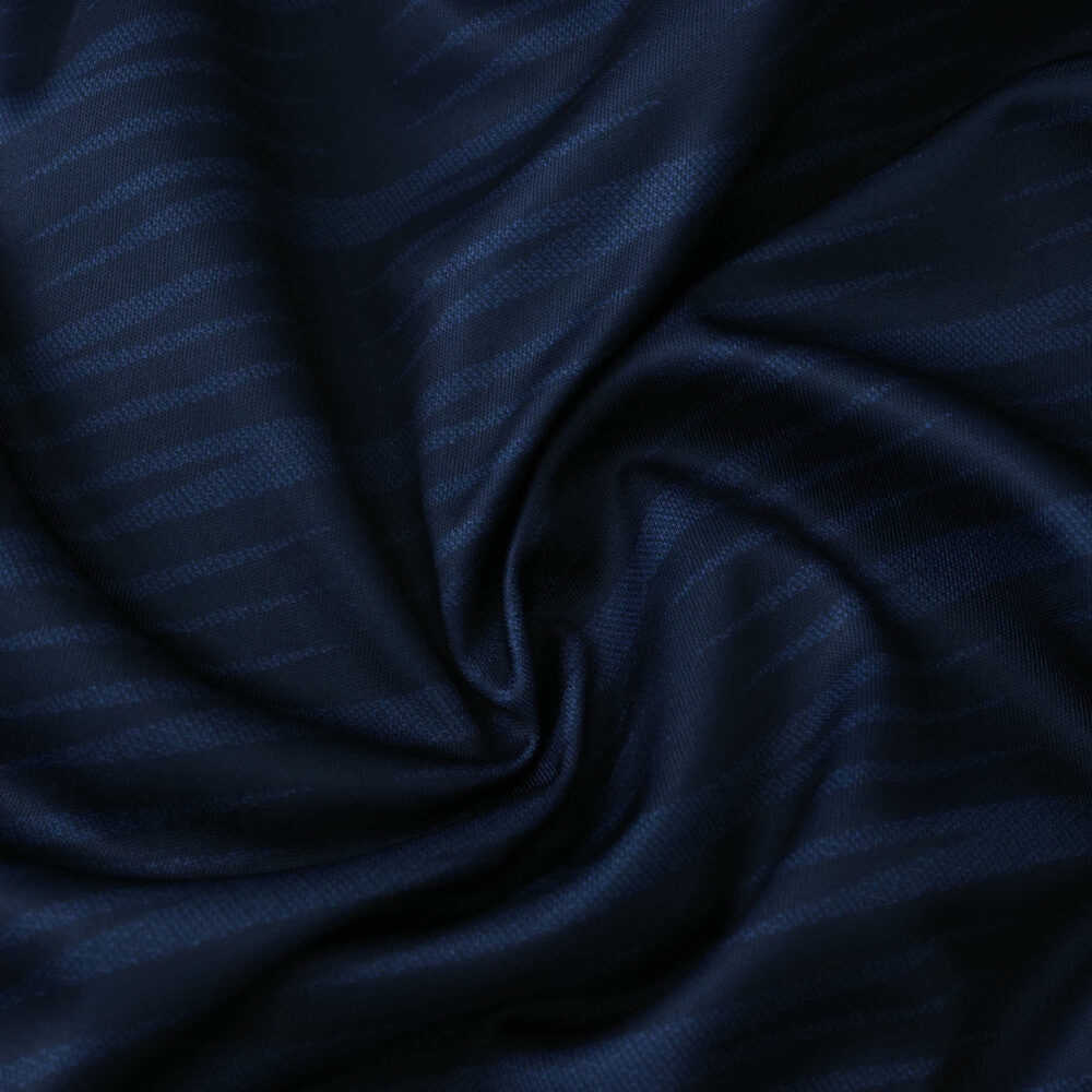 Close-up of dark blue Celta Vigo Away 2025/26 Fan Version jersey fabric with subtle textured pattern.