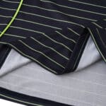 Close-up of 2025/26 Celtic Away Fan Version jersey showing navy fabric with green pinstripes and stitching.