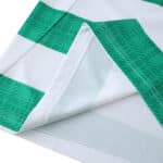 Close-up of the hem stitching on the Celtic Home 2025/26 Fan Version jersey with green and white stripes.