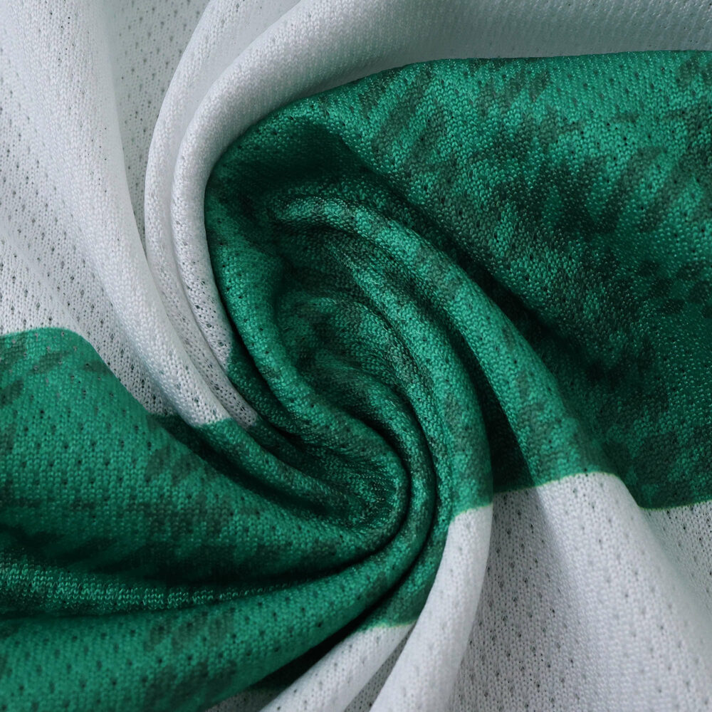 Close-up of the Celtic Home 2025/26 Player Version jersey fabric showing green and white pattern.