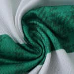Close-up of the Celtic Home 2025/26 Player Version jersey fabric showing green and white pattern.