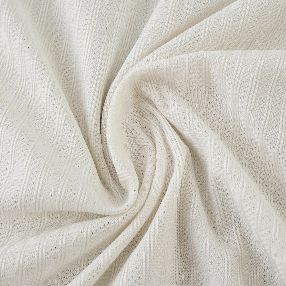 Close-up of Chelsea Away 2025/26 Player Version jersey fabric in an off-white color with subtle textured patterns.