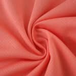 Close-up of the coral pink fabric used in the FC Porto Away 2025/26 Fan Version jersey.