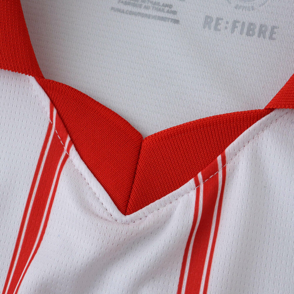 Close-up of the Girona Home 2025/26 Fan Version jersey collar with red V-neck and white fabric with red stripes.