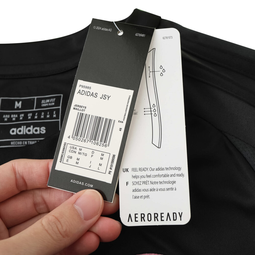 Close-up of Inter Miami CF Away 2025/26 Fan Version jersey tags, featuring size and care details.