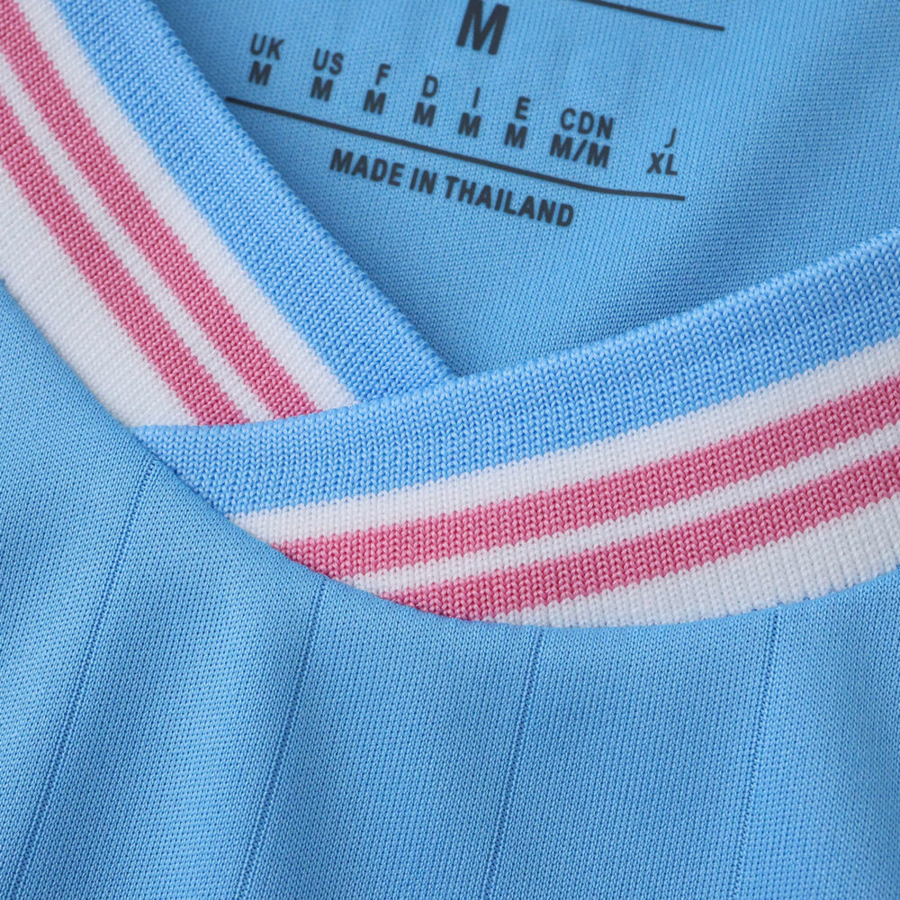 Close-up of Inter Miami CF Third 2025/26 Fan Version jersey collar in light blue with pink and white stripes.