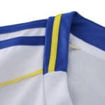 Close-up of Leeds United 2025/26 Home fan jersey collar with blue and yellow trim detailing.