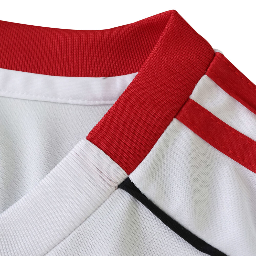 Close-up of the Liverpool Away 2025/26 Fan Version collar, featuring red and white details with stripe accents.