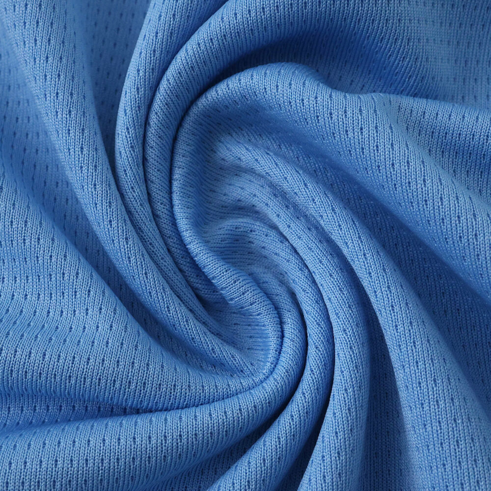 Close-up of the Manchester City 2025/26 fan home jersey fabric, showing its texture and sky blue color.
