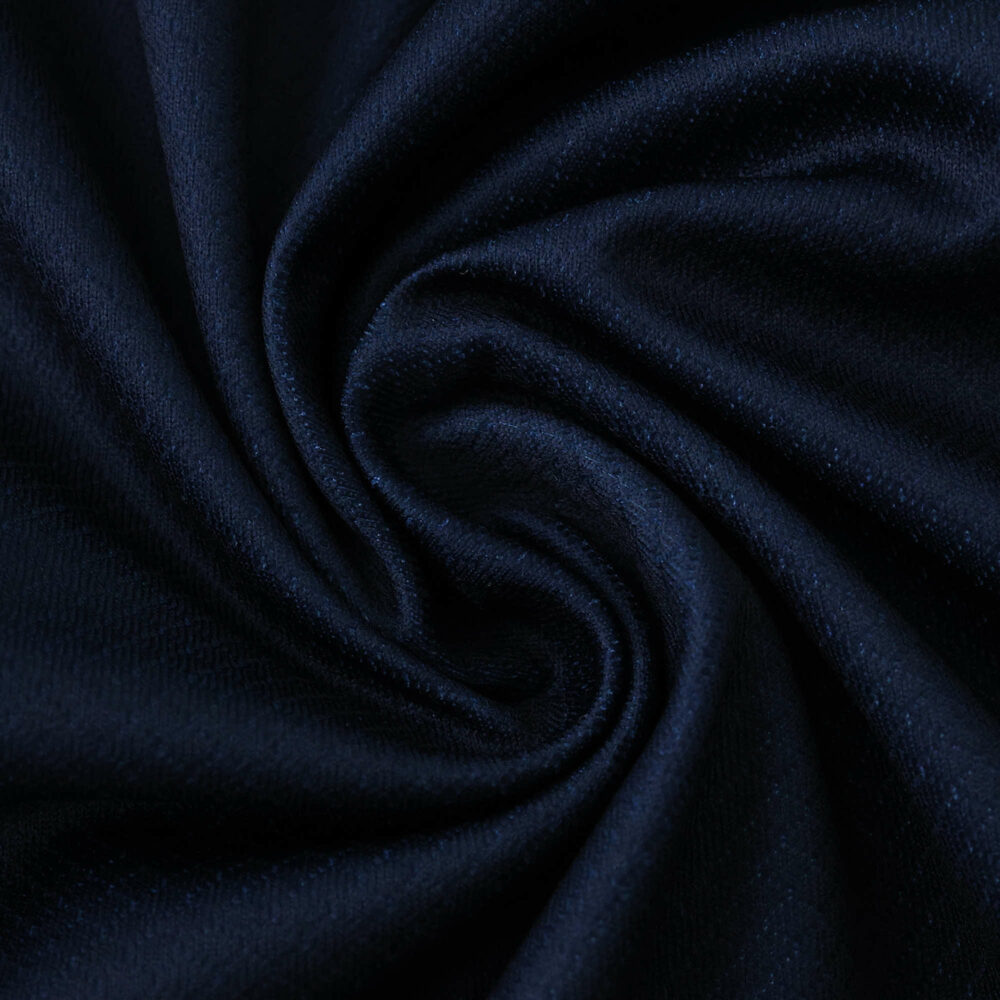 Close-up of Paris Saint-Germain 2025/26 home fan version jersey fabric in deep navy blue.