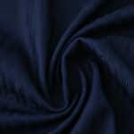 Close-up of the Paris Saint-Germain 2025/26 home player version jersey fabric in dark blue.