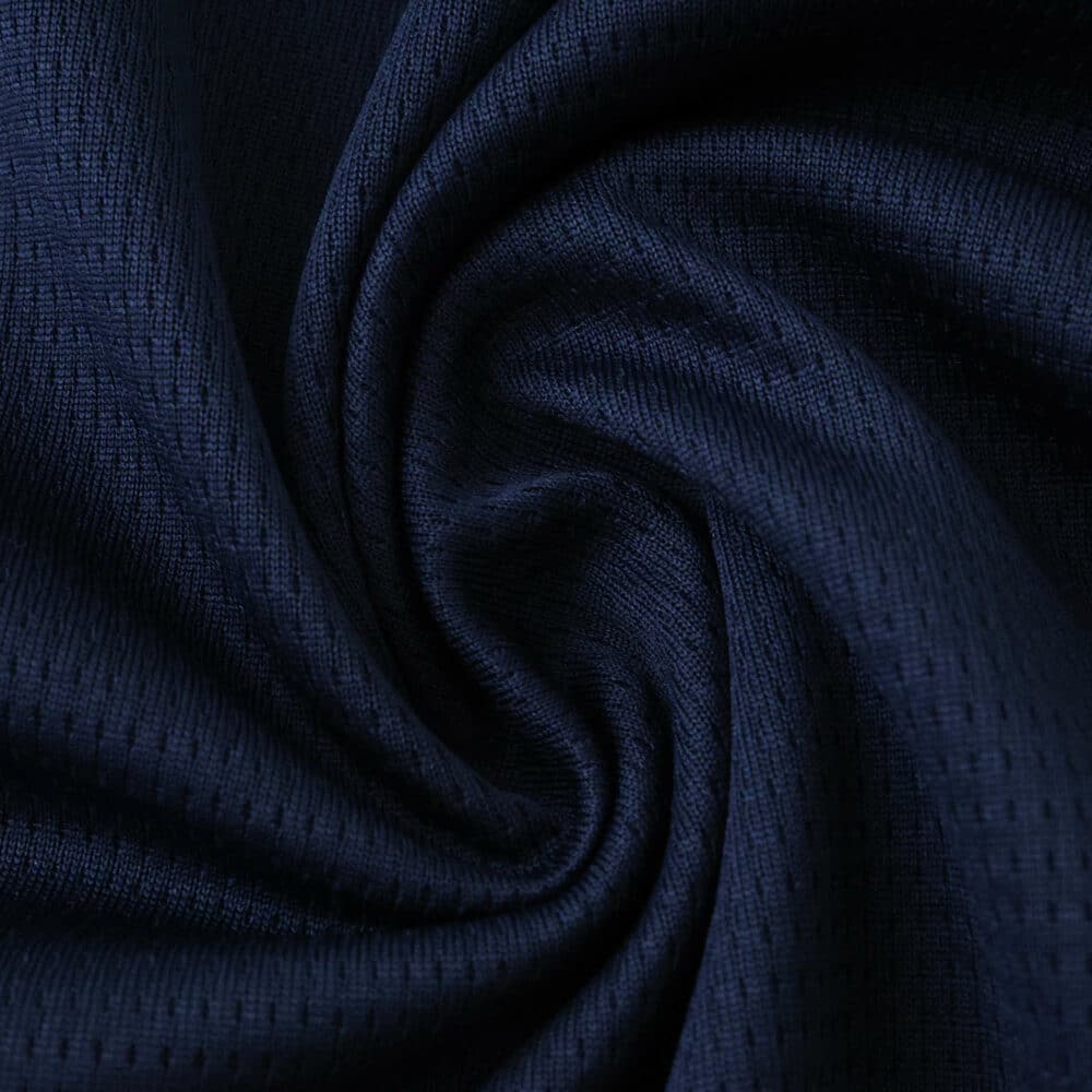 Close-up of dark blue PSV Eindhoven Away 2025/26 Fan Version jersey fabric with textured pattern.