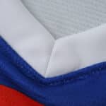 Close-up of the neckline on the Rangers Away 2025/26 Fan Version jersey, showing white, blue, and red fabric.