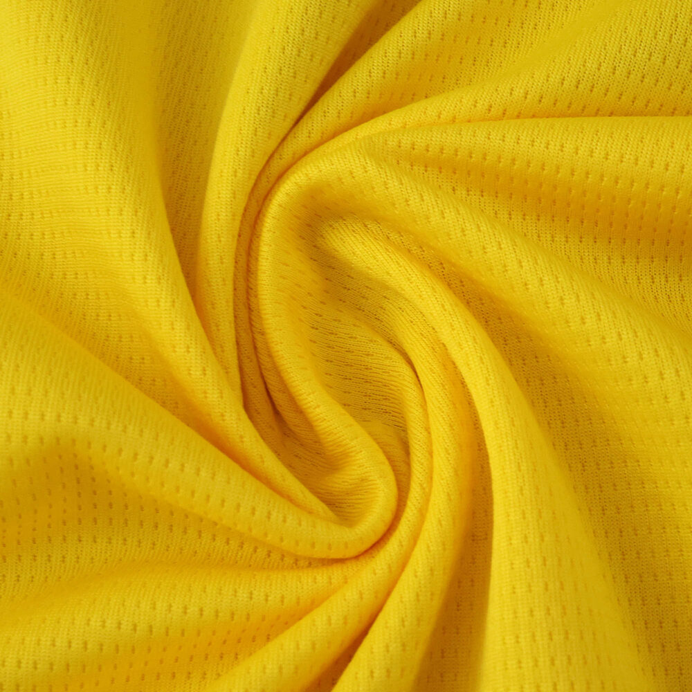 Close-up of yellow RC Lens 2025/26 home fan jersey fabric, showing texture and detail.