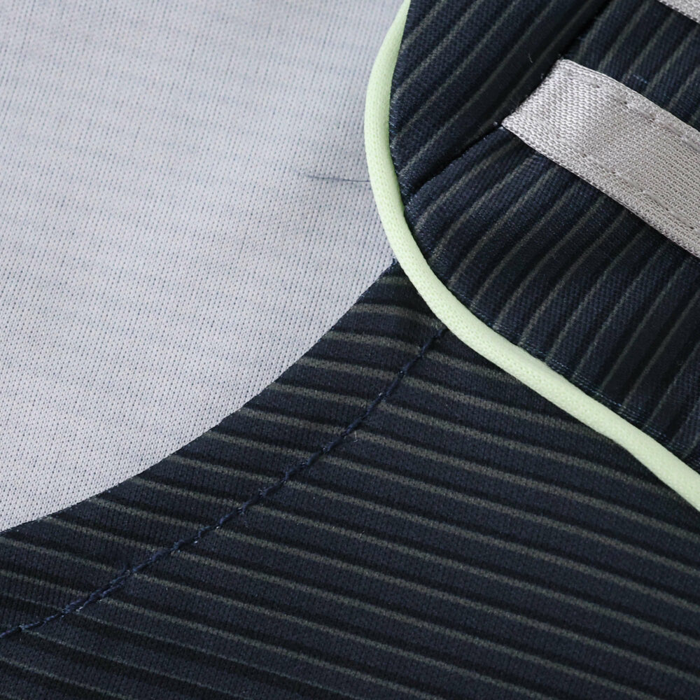 Close-up of the 2025/26 Real Madrid Away Fan Version jersey showing dark stripes and contrasting trim.