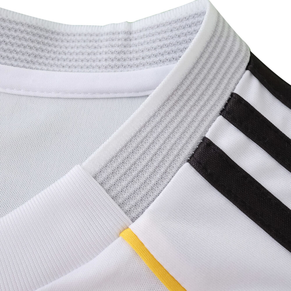 Close-up of the Real Madrid 2025/26 Home Fan jersey collar with black stripes and a yellow accent.