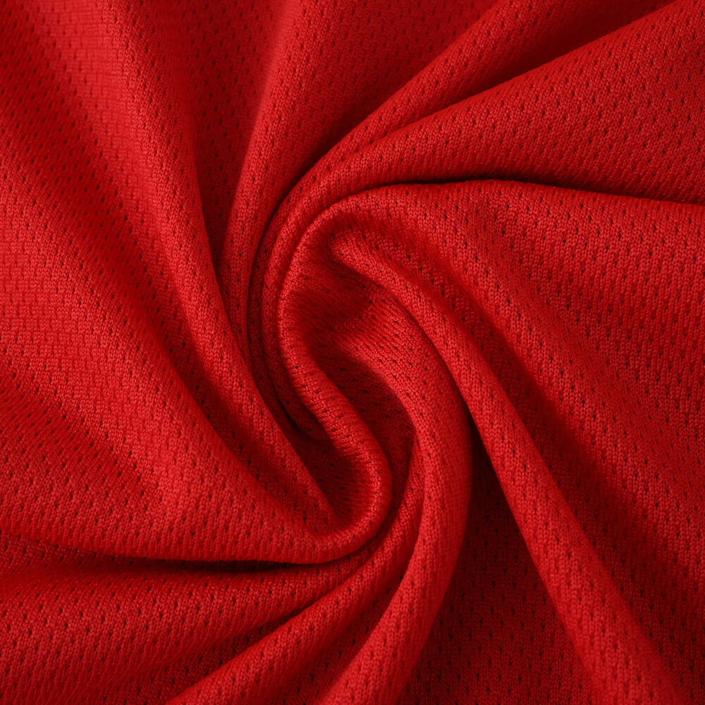 Close-up of red SL Benfica Home 2025/26 Player Version jersey fabric with mesh texture.