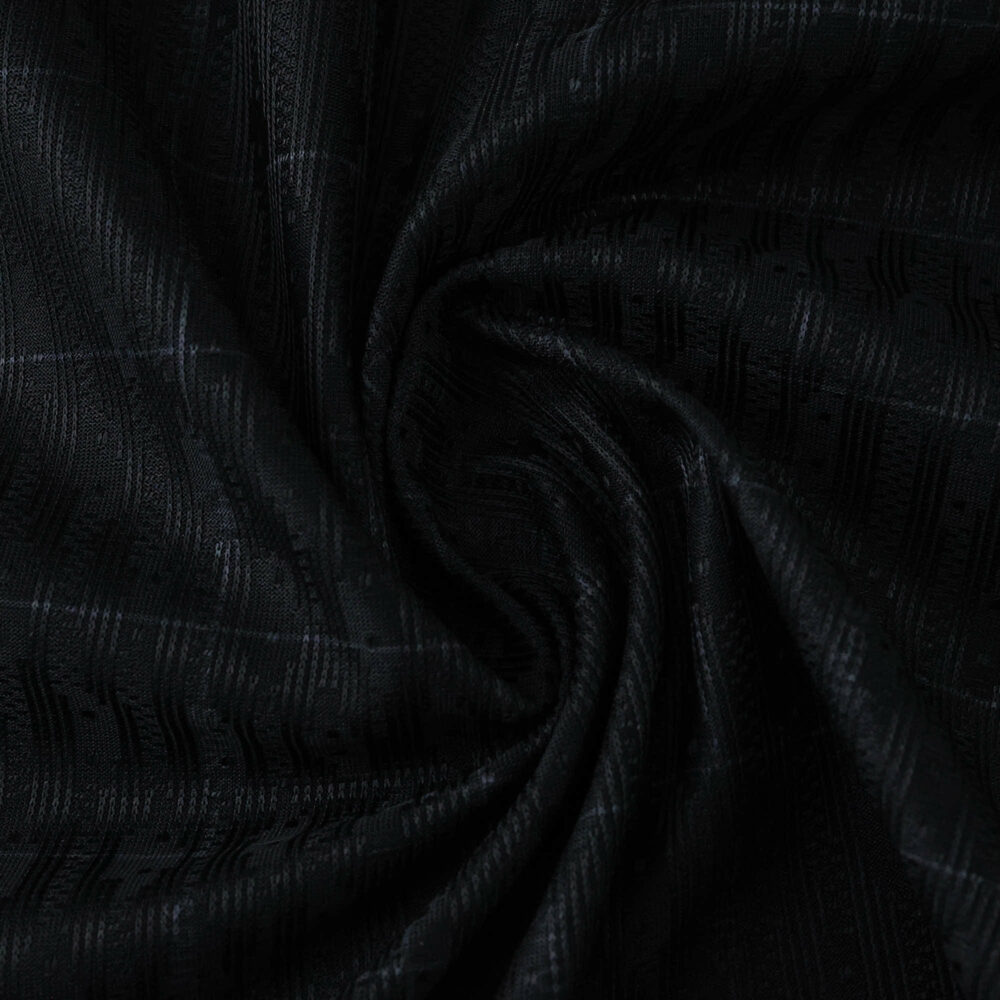 Close-up of the Tottenham Hotspur 2025/26 Away Player Version jersey fabric in dark textured material.