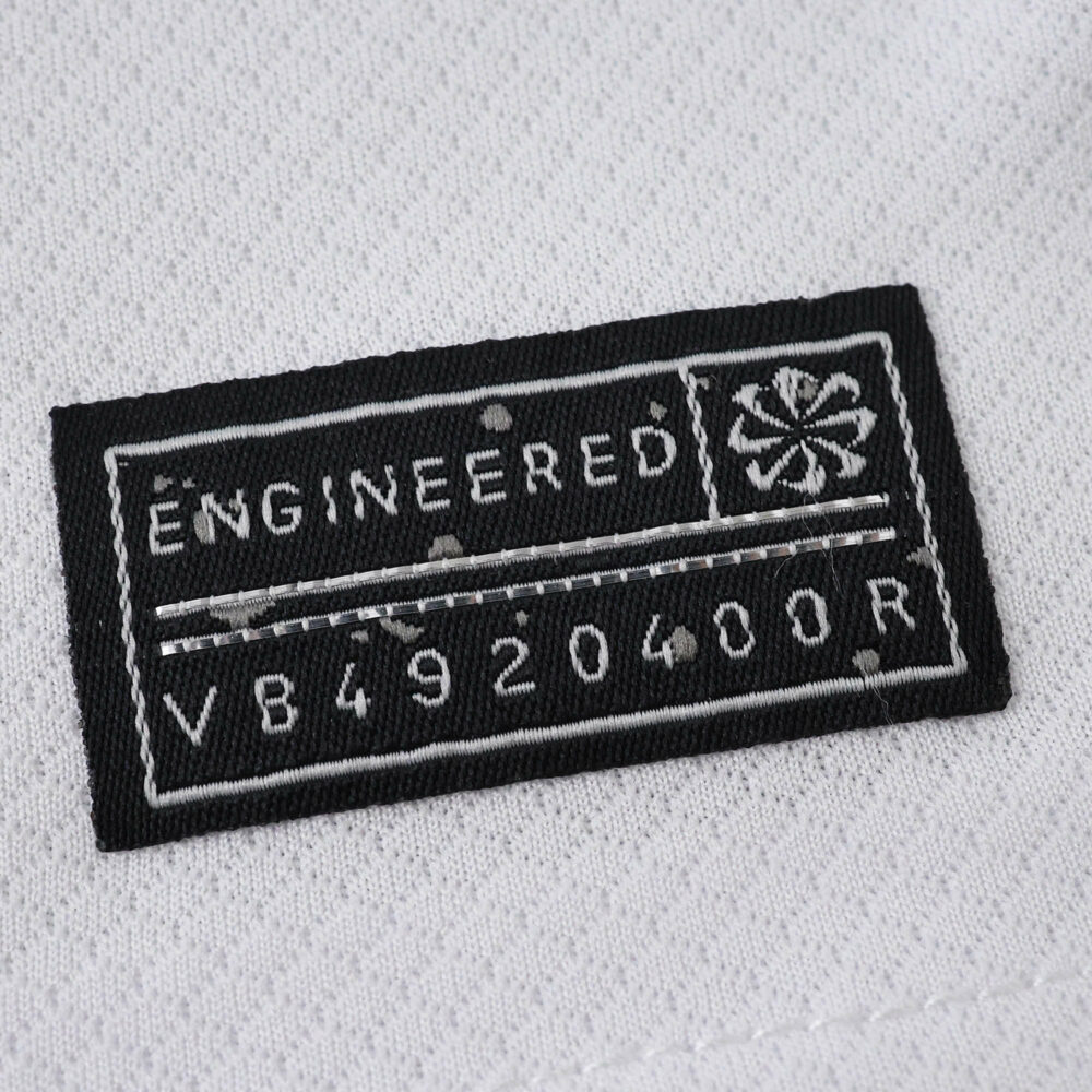 Close-up of the "Engineered" authenticity label on the 2025/26 Tottenham Hotspur Home Fan Version jersey.
