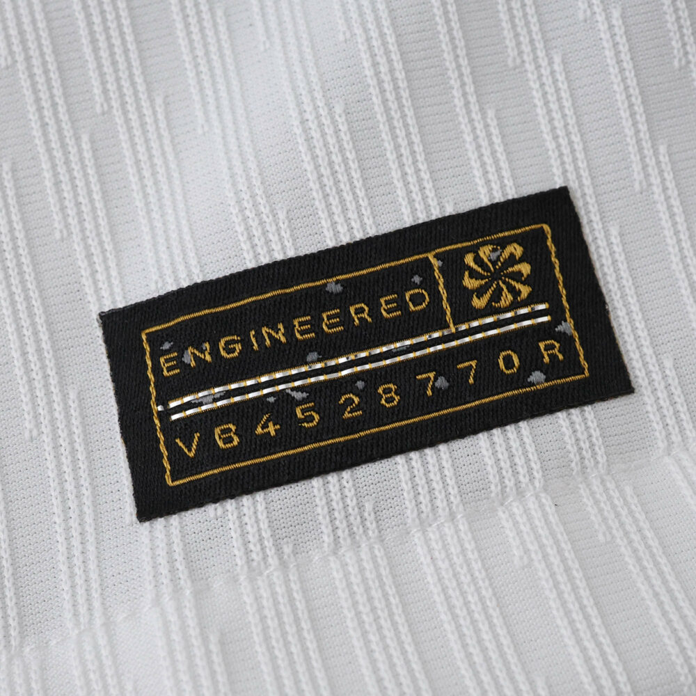 Close-up of the "Engineered" authenticity tag on the Tottenham Hotspur 2025/26 Home Player Version jersey.