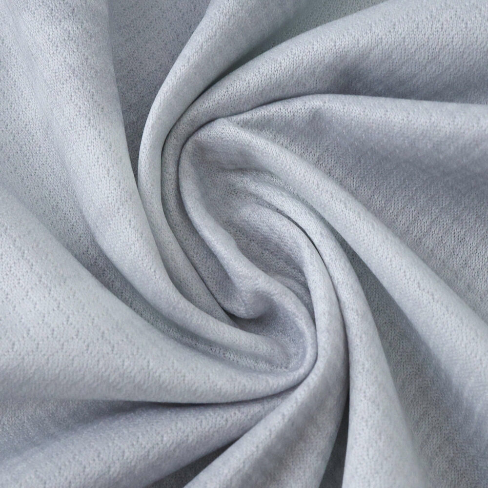 Close-up of the light grey VfL Wolfsburg 2025/26 Away Fan Version jersey fabric.