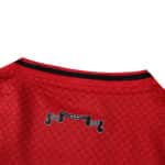 Close-up of the back collar on the Ajax 2025/26 Fan Version jersey featuring a black ribbon design.