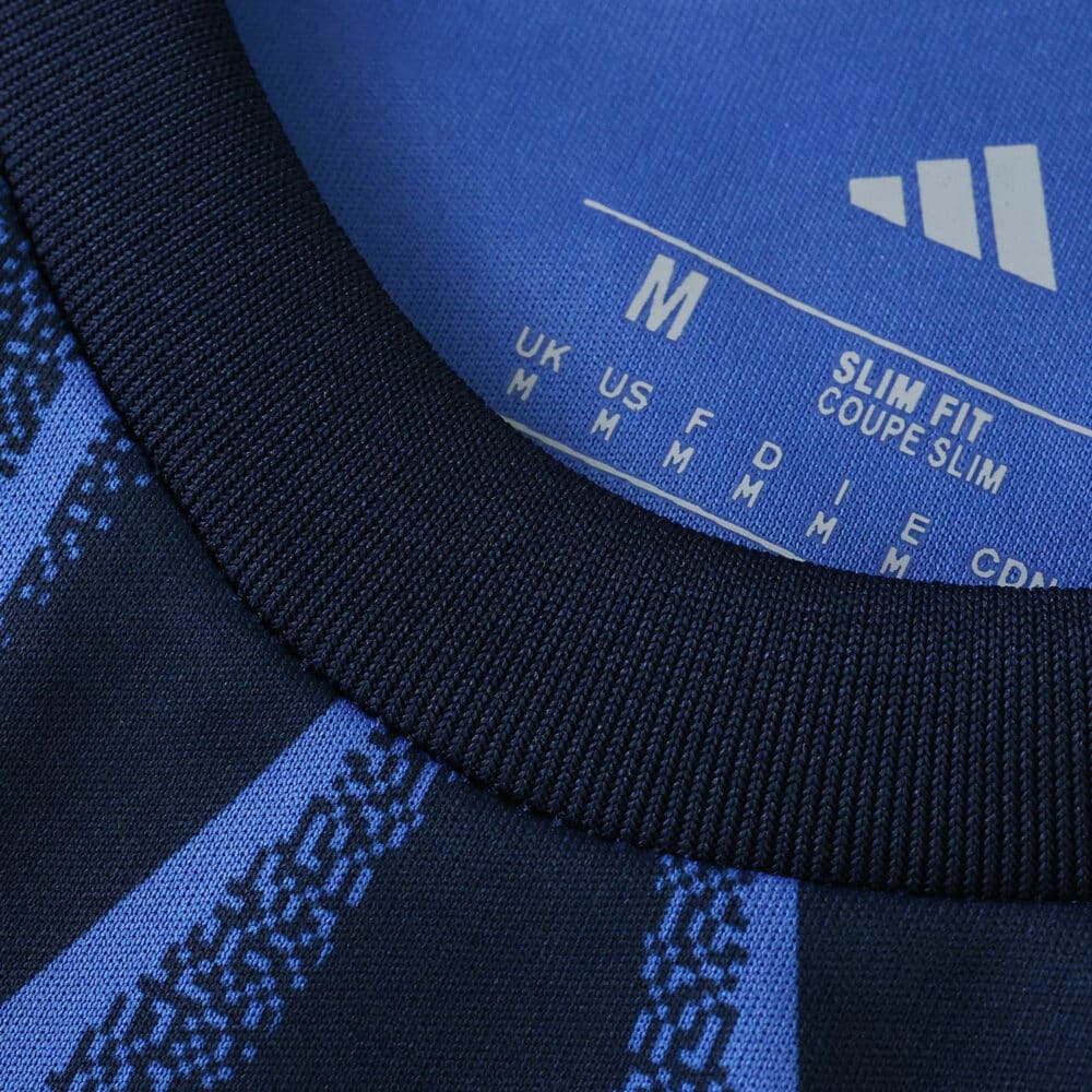 Close-up of the collar and inner label of the Arsenal Away 2025/26 Fan Version jersey in blue.