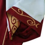 Close-up of Aston Villa 2025/26 home fan jersey sleeve, featuring maroon and gold swirl detailing.
