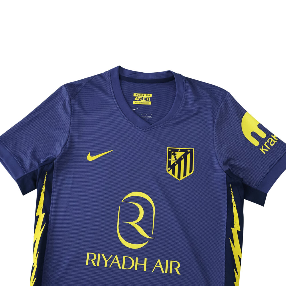 Atlético Madrid Away 2025/26 Fan Version jersey in dark blue with yellow accents and sponsor logos.