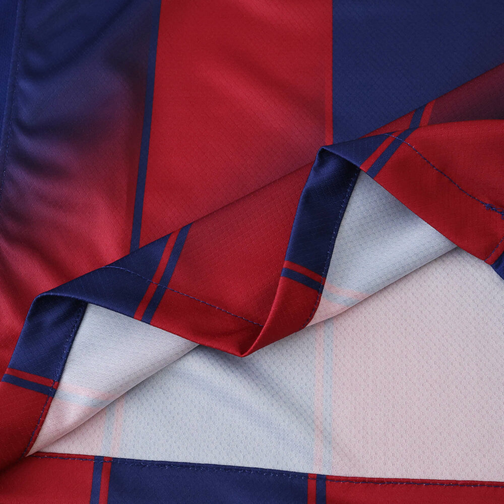 Close-up of the Barcelona Home 2025/26 Fan Version jersey fabric showing red and blue stripes.
