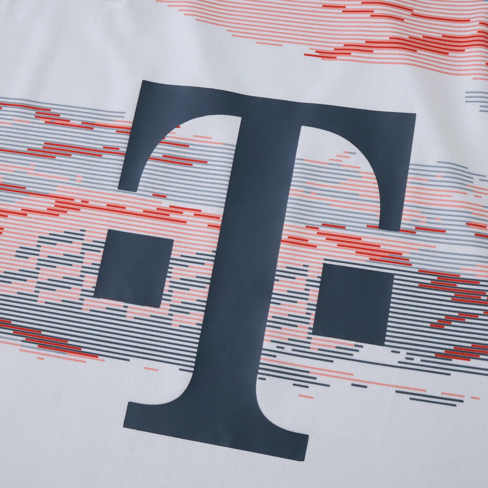 Close-up of Bayern Munich Away 2025/26 Fan Version jersey with sponsor logo and red graphic pattern.