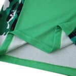 Close-up of Borussia Monchengladbach Away 2025/26 Fan Version jersey hem in green with camouflage detail.