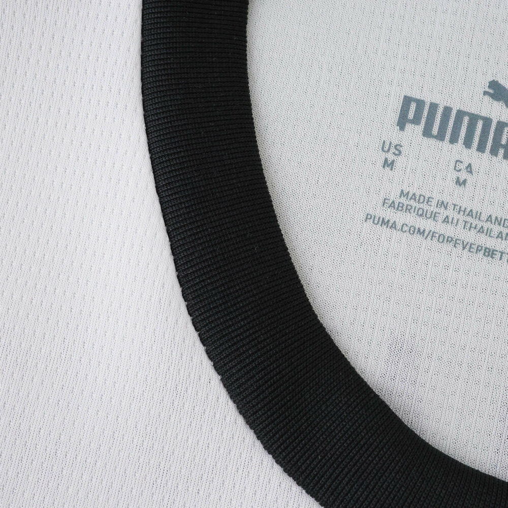 Close-up of Borussia Monchengladbach 2025/26 home fan jersey collar with Puma branding on inner neckline.