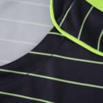 Close-up of the Celtic Away 2025/26 Fan Version jersey featuring light green stripes on dark fabric.