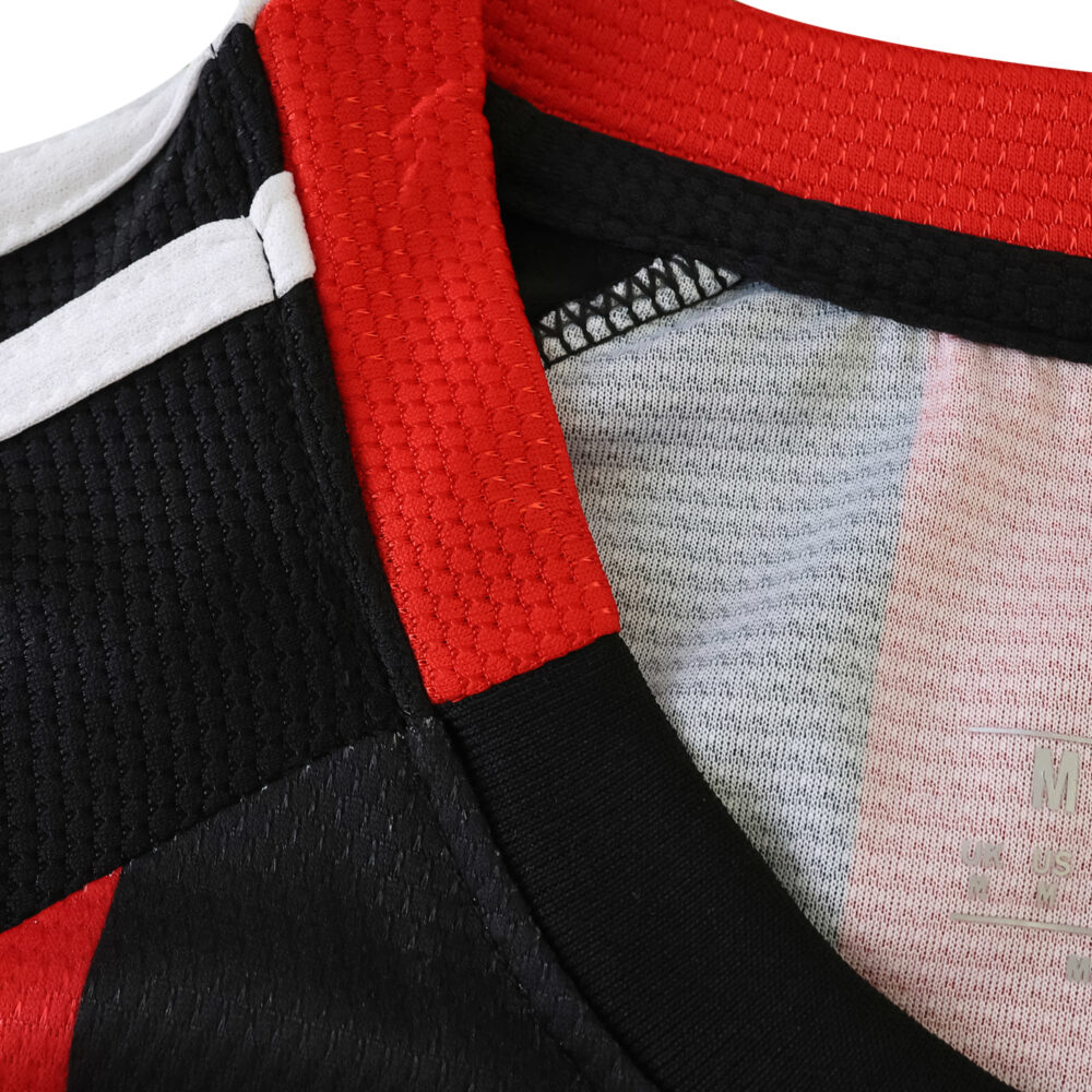 Close-up of Eintracht Frankfurt 2025/26 home fan jersey collar featuring red, black, and white details.