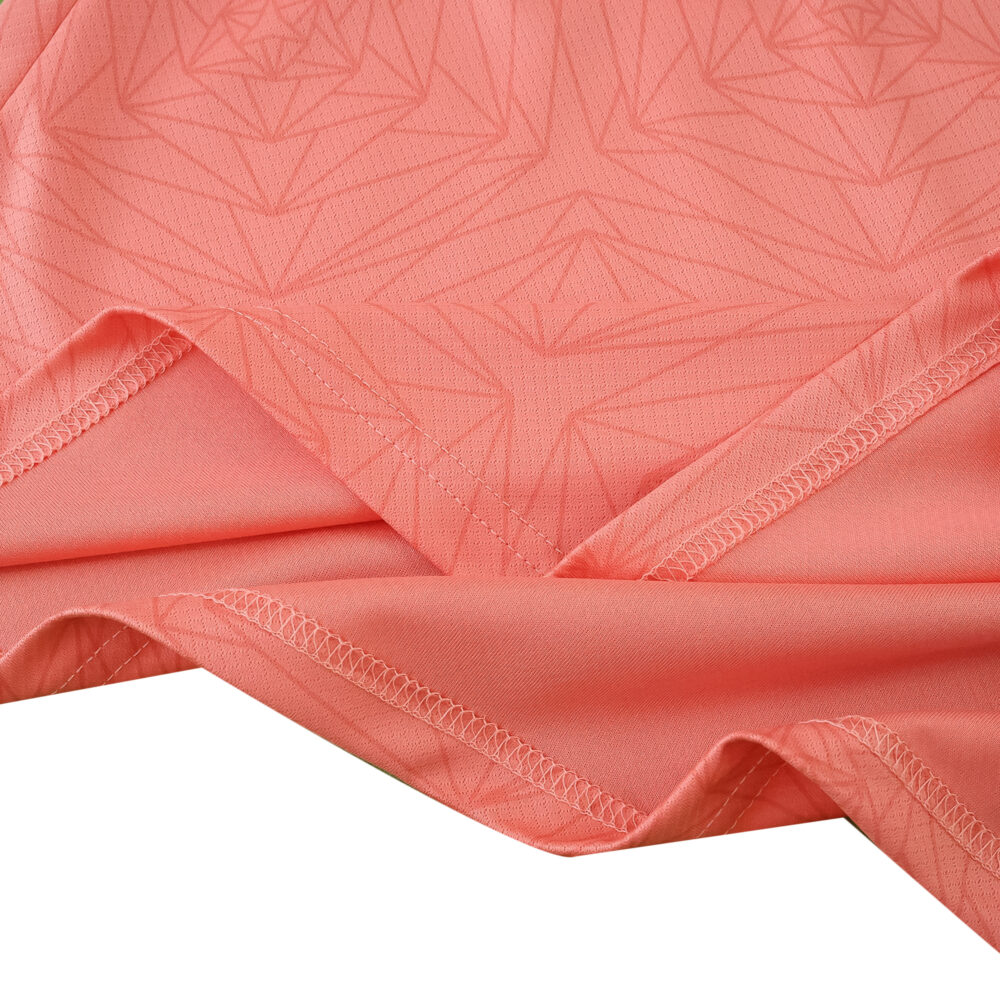 Close-up of FC Porto Away 2025/26 Fan Version jersey fabric showing pink color and geometric pattern.
