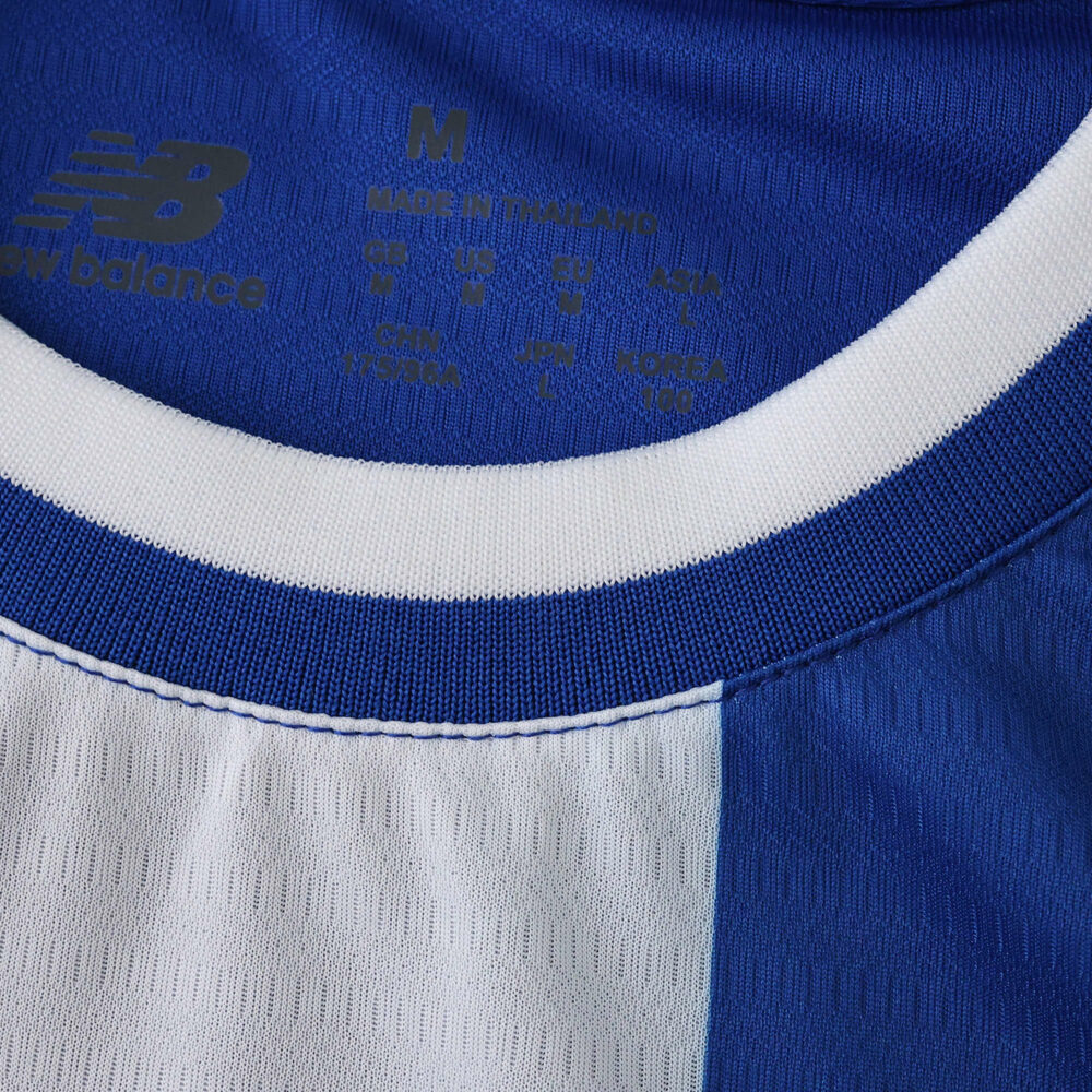 Close-up of FC Porto 2025/26 home fan jersey collar showing blue and white stripes and New Balance logo.