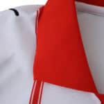 Close-up of the red collar and white fabric with stripes on the Girona Home 2025/26 Fan Version jersey.