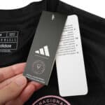 Product tag and label attached to the Inter Miami CF 2025/26 Away Fan Version jersey in black.